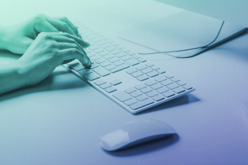 Photo of hands typing at a keyboard used as the feature image for an article titled 'Websites, word counts, and SEO—how many words do you actually need to rank well?'.